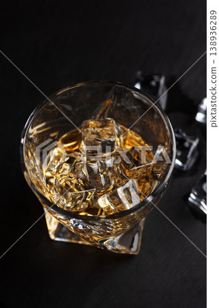 Whiskey Glass with Ice. Sophisticated Bar Ambience 138936289