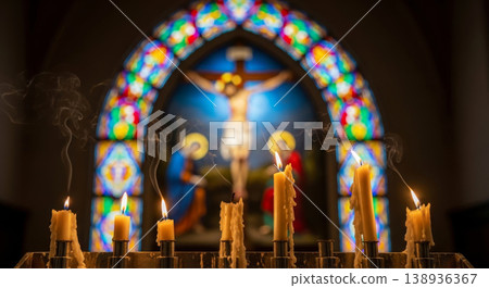 Mysterious church atmosphere with burning church candles on the background of a blurred crucifix Mysterious church atmosphere with burning church candles on the background of a blurred crucifix 138936367
