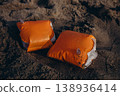 Inflatable armbands on sandy beach Child water safety concept swimming protection and learning basics of safe behavior near sea 138936414
