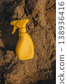 Yellow sunscreen spray bottle on dry sand beach Summer sun protection concept minimal cosmetic product mockup with copy space 138936416