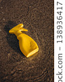 Yellow sunscreen spray bottle lying in shallow sea water on sandy beach Summer sun protection concept minimal product mockup 138936417