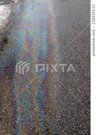 Rainbow Oil Spill Flowing Along Asphalt Road Urban Pollution Concept Rainbow Oil Spill Flowing Along Asphalt Road Urban Pollution Concept 138936532