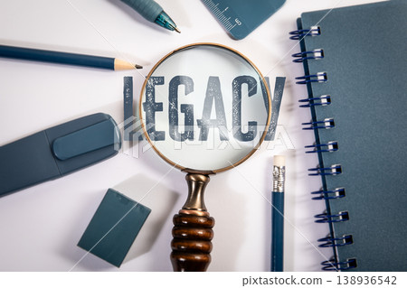 Legacy Word Seen Through Magnifying Glass on Desk 138936542