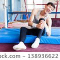 Injured male gymnast suffering from knee pain after bad landing 138936622