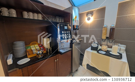 Buffet breakfast area with coffee machine, juice machine, cereal containers and tea Buffet breakfast area with coffee machine, juice machine, cereal containers and tea 138936712