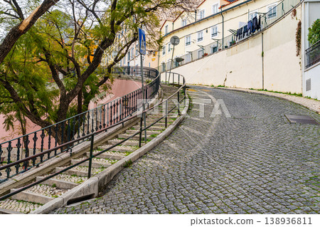 Curved Cobblestone Street With Stairs In Lisbon Residential Area 138936811