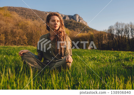 Woman Sitting in Meadow Enjoying Sunlight in Early Spring Woman Sitting in Meadow Enjoying Sunlight in Early Spring 138936840