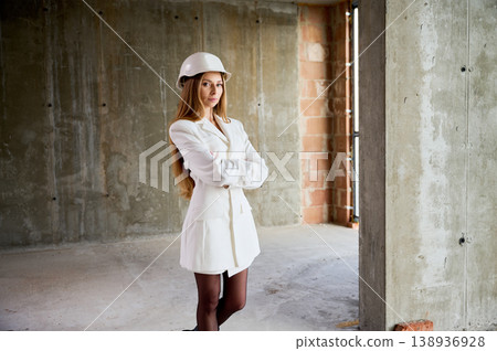 Woman as prospective buyer stands inside empty apartment under construction. Concept of residential investment, home selection, urban living and commercial use 138936928