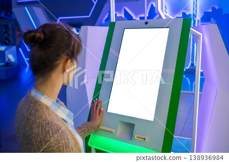 White screen concept - woman looking at blank white display kiosk at exhibition 138936984
