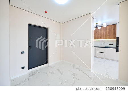 Contemporary residential corridor featuring polished tile flooring, multiple open doors and soft neutral walls. Stylish apartment interior, elegant renovation and real estate concept 138937009