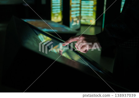 Man using interactive touchscreen display at modern museum or exhibition Man using interactive touchscreen display at modern museum or exhibition 138937039