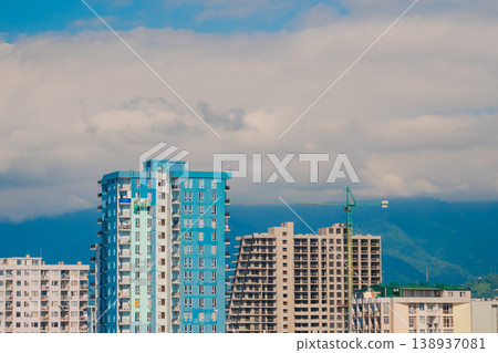 Turquoise tower crane and unfinished building construction Turquoise tower crane and unfinished building construction 138937081