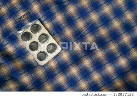 Help.Blister pack of medicinal capsules in a shirt pocket 138937128
