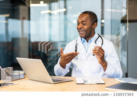 Smiling male doctor discussing treatment options and explaining medication details during a virtual telehealth appointment, offering remote healthcare support to a patient Smiling male doctor discussing treatment options and explaining medication details during a virtual telehealth appointment, offering remote healthcare support to a patient 138937365
