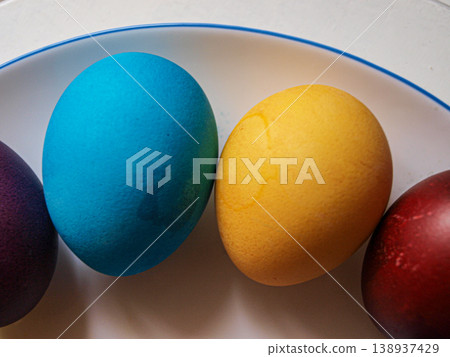 Yellow and blue Easter coloring eggs in a row of colorful ones. Yellow and blue Easter coloring eggs in a row of colorful ones. 138937429