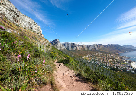 Scenic hiking trail on a mountain. The twelve apostles in Cape Town, South Africa with plants against a blue sky. Relaxing view of a beautiful and rugged natural landscape to explore and travel Scenic hiking trail on a mountain. The twelve apostles in Cape Town, South Africa with plants against a blue sky. Relaxing view of a beautiful and rugged natural landscape to explore and travel 138937550