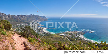 Scenic hiking trail along Table Mountain with beautiful views of a coastal city against a blue sky background. Magnificent panoramic of peaceful and rugged landscape at the sea to explore and travel Scenic hiking trail along Table Mountain with beautiful views of a coastal city against a blue sky background. Magnificent panoramic of peaceful and rugged landscape at the sea to explore and travel 138937569