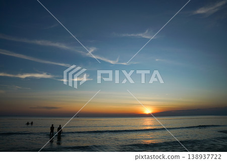 Two person enjoy the sunset sea on beach. Summer vacations and Holiday travel conceps. Two person enjoy the sunset sea on beach. Summer vacations and Holiday travel conceps. 138937722