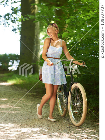 Bicycle, walking and woman with a smile, nature and outdoor with sunshine, fresh air and wellness. Person, park and girl with a bike, happiness and thinking with health, trees and activity with hobby Bicycle, walking and woman with a smile, nature and outdoor with sunshine, fresh air and wellness. Person, park and girl with a bike, happiness and thinking with health, trees and activity with hobby 138937737