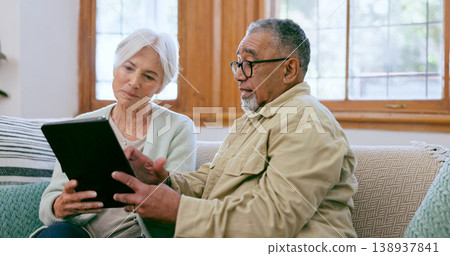 Tablet, love and an elderly couple on a sofa in the living room of their home to search social media together. Diversity, app or technology with a senior man and woman in the apartment for retirement Tablet, love and an elderly couple on a sofa in the living room of their home to search social media together. Diversity, app or technology with a senior man and woman in the apartment for retirement 138937841