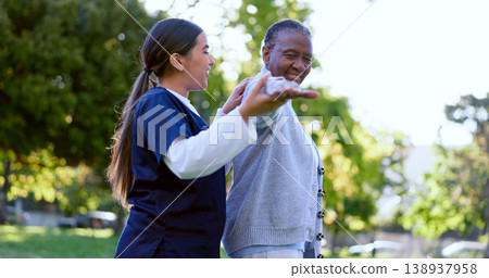 Senior, woman and caregiver with arm stretching for exercise, workout or fitness in a park with smile. People, professional or nurse with activity for physiotherapy, wellness and health in nature 138937958
