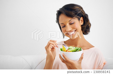 Happy woman, bowl and eating salad for healthy diet, natural nutrition or wellness on living room sofa at home. Female person, vegan or nutritionist smile for vegetarian meal, fiber or vitamin snack 138938141