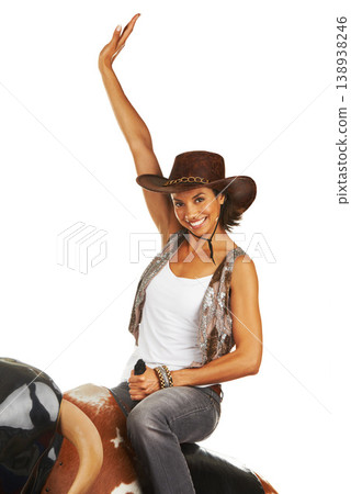 Woman, sitting and hands up on rodeo bull machine for cowboy, western fashion portrait and studio mockup. Workout, athlete and smile face for wellness, health body and texas sport by white background Woman, sitting and hands up on rodeo bull machine for cowboy, western fashion portrait and studio mockup. Workout, athlete and smile face for wellness, health body and texas sport by white background 138938246