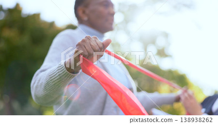 Woman, hand and resistance band for physiotherapy with exercise in garden, backyard or outdoors. Elderly person, stretching and rehabilitation for mobility with trust, support or help for wellness Woman, hand and resistance band for physiotherapy with exercise in garden, backyard or outdoors. Elderly person, stretching and rehabilitation for mobility with trust, support or help for wellness 138938262