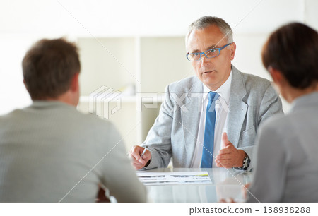 Man, leader and discussion at business meeting, conversation and feedback or review in training. Mature businessman, employees and communication in workshop, agenda and planning for future growth 138938288