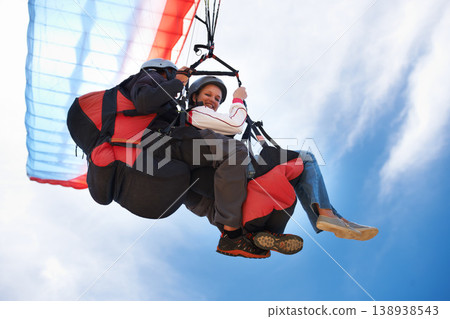 People, paragliding and freedom in sky, together or extreme sport with smile for fitness. Coach, partnership and person on adventure, helmet or fearless with backpack, parachute or flight in portrait People, paragliding and freedom in sky, together or extreme sport with smile for fitness. Coach, partnership and person on adventure, helmet or fearless with backpack, parachute or flight in portrait 138938543