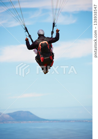 People, paragliding and freedom in sky, ocean and extreme sport with back for fitness. Coach, partnership and person with adventure, helmet and fearless with backpack, parachute and sea with safety 138938547