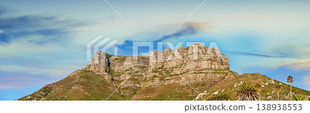 Low angle view of a mountain peak against a stunning colorful sky in South Africa. Scenic panorama landscape of a remote hiking location near Cape Town. Travel and explore nature through adventure Low angle view of a mountain peak against a stunning colorful sky in South Africa. Scenic panorama landscape of a remote hiking location near Cape Town. Travel and explore nature through adventure 138938553