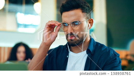 Man, reading glasses and cafe for online research, remote work and review of website and analysis. Freelancer worker or designer in coffee shop or restaurant with computer and music for internet info 138938761