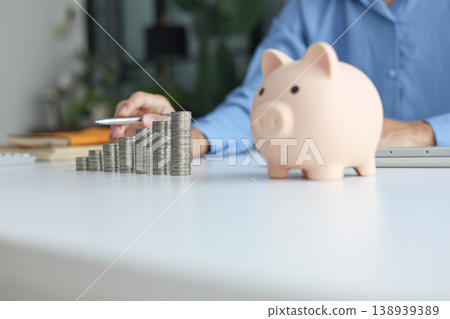 Growing money stacks and piggy bank symbolizing economic growth and stability. 138939389