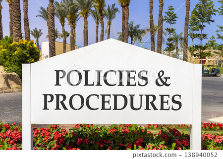 Policies and procedures symbol. Concept words Policies and procedures on beautiful big white road sign. Beautiful blue sky palm trees background. Business policies procedures concept. Copy space 138940052