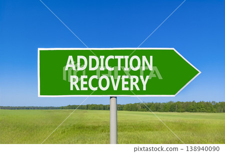 Addiction recovery symbol. Concept words Addiction recovery on beautiful green road sign. Beautiful blue sky green grass field background. Psychology addiction recovery concept. Copy space. Addiction recovery symbol. Concept words Addiction recovery on beautiful green road sign. Beautiful blue sky green grass field background. Psychology addiction recovery concept. Copy space. 138940090