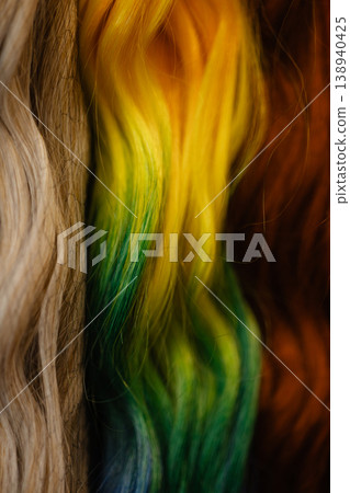 Colorful wavy hair extensions texture background with gradient strands Colorful wavy hair extensions texture background with gradient strands 138940425