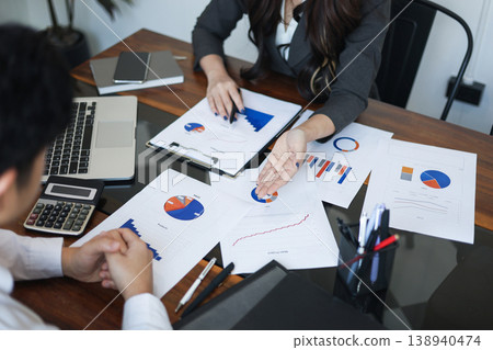 Businesspeople coworker reviewing document report together in the meeting room Businesspeople coworker reviewing document report together in the meeting room 138940474
