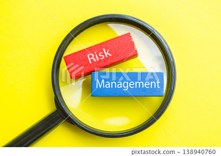 Risk Management text under magnifying glass representing risk assessment and control Risk Management text under magnifying glass representing risk assessment and control 138940760