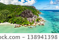 Granite rocks meeting turquoise water on a tropical coastline with lush greenery. Anse Source d'Argent. Seychelles, La Digue. 138941398