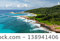 The turquoise ocean blending into the lush, green coastline with rocky formations. La Digue, Seychelles. 138941406