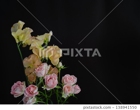 Beautiful fresh roses and sweet peas against a black background. 138941550