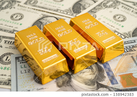 Gold bar on US dollar and Euro banknote, economy finance exchange trade investment. 138942383