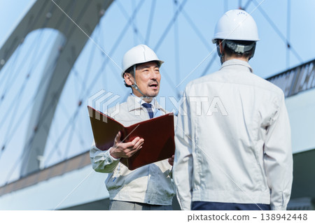 Civil engineers having a meeting on site Civil engineers having a meeting on site 138942448