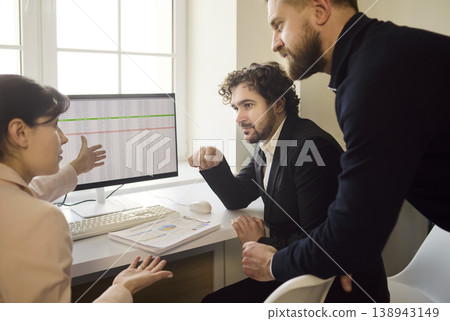 Colleagues analyze financial data during strategy meeting in bright modern office Colleagues analyze financial data during strategy meeting in bright modern office 138943149