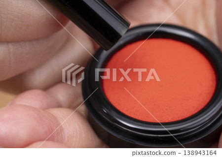The hand applying red ink to the seal 138943164