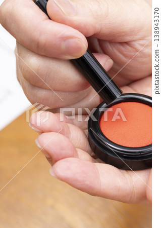 The hand applying red ink to the seal The hand applying red ink to the seal 138943170