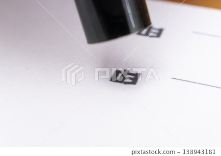 The hand applying red ink to the seal The hand applying red ink to the seal 138943181