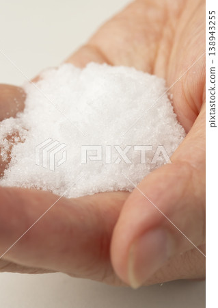 Salt placed in the palm of your hand Salt placed in the palm of your hand 138943255