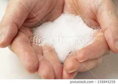 Salt placed in the palm of your hand Salt placed in the palm of your hand 138943259